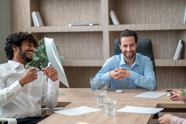An image of a person confidently negotiating at a table, with financial documents nearby. The person is smiling and engaged in a positive manner.