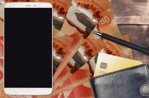 A close-up shot of an Australian 50 dollar note placed next to a budgeting app interface on a smartphone, with graphs showing expense breakdowns.