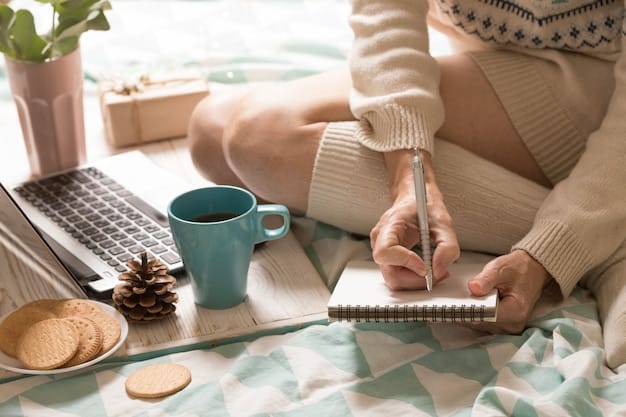 A person sitting at a wooden desk, writing down budgeting ideas on a notepad with a pen. A laptop and a mug of coffee are also visible on the desk, creating a cozy and productive atmosphere.