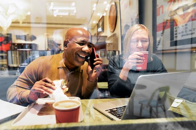A diverse group of people at a coffee shop, discussing finances and loan options over coffee, with open laptops showing interest rate comparisons.