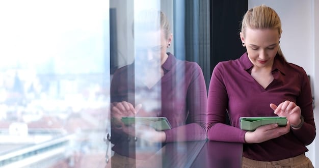 A person on the phone with a provider, with a determined look on their face, holding notes of competitor prices. The background is a modern office setting.