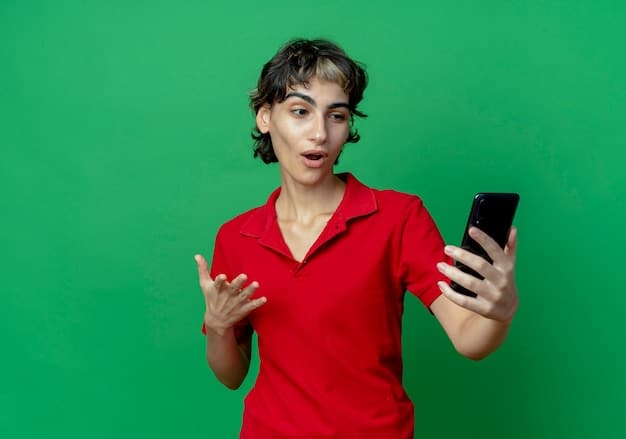 A person with a surprised expression looking at their mobile banking app on their smartphone, with the app displaying a notification about reaching a savings goal. There is a sense of satisfaction and excitement on their face.
