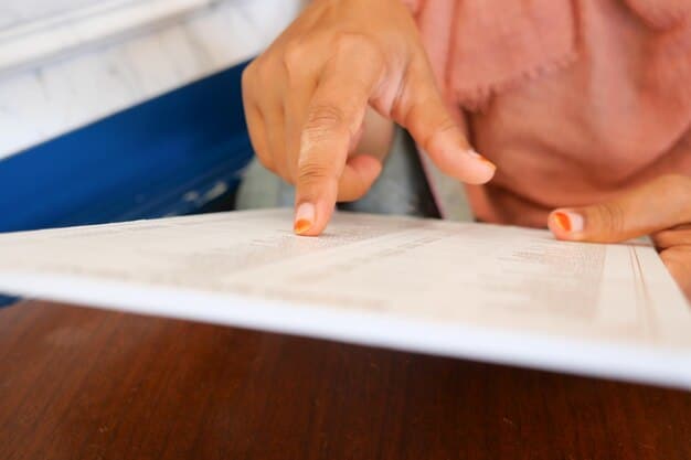 A close-up shot of an official Australian government document detailing changes to the Family Tax Benefit, with a hand pointing to a specific section of the document.